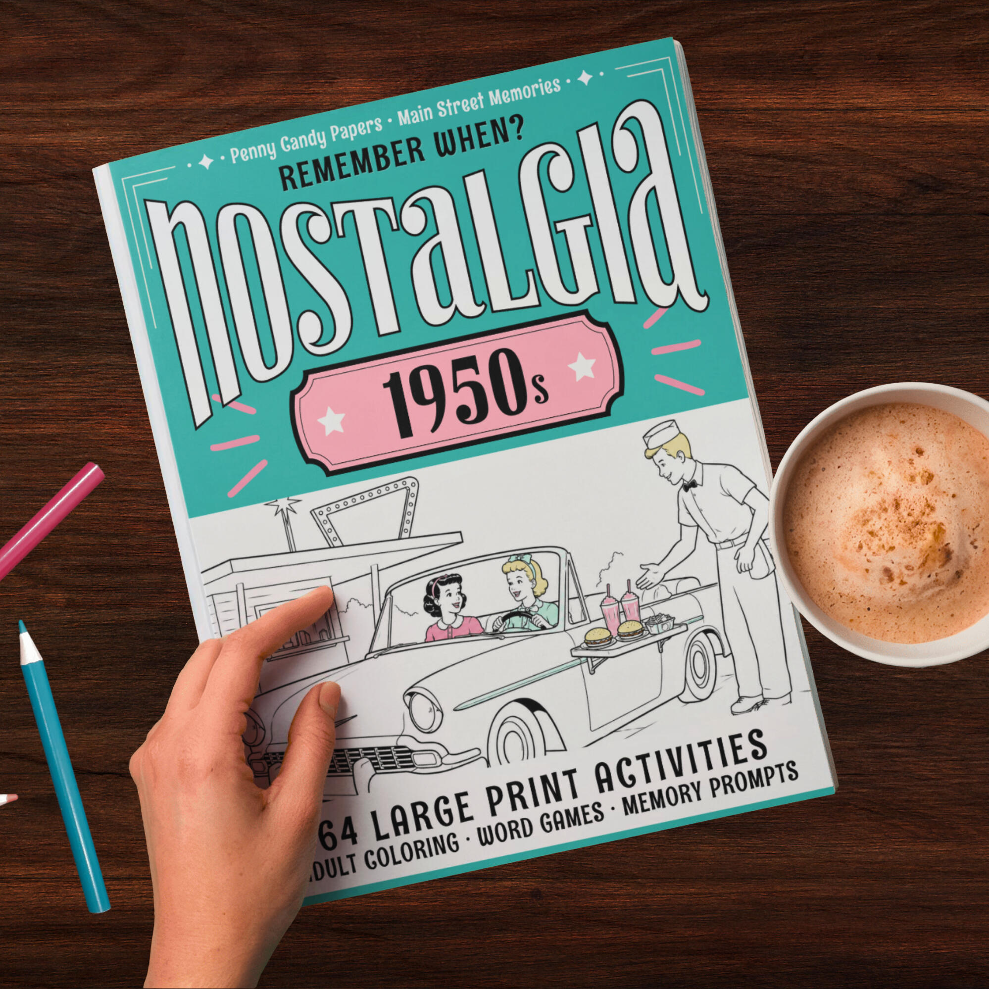 1950s nostalgia activity book cover from Penny Candy Papers 1950s nostalgia activity book featuring a drive in car hop diner from Penny Candy Papers beside coffee and colored pencils